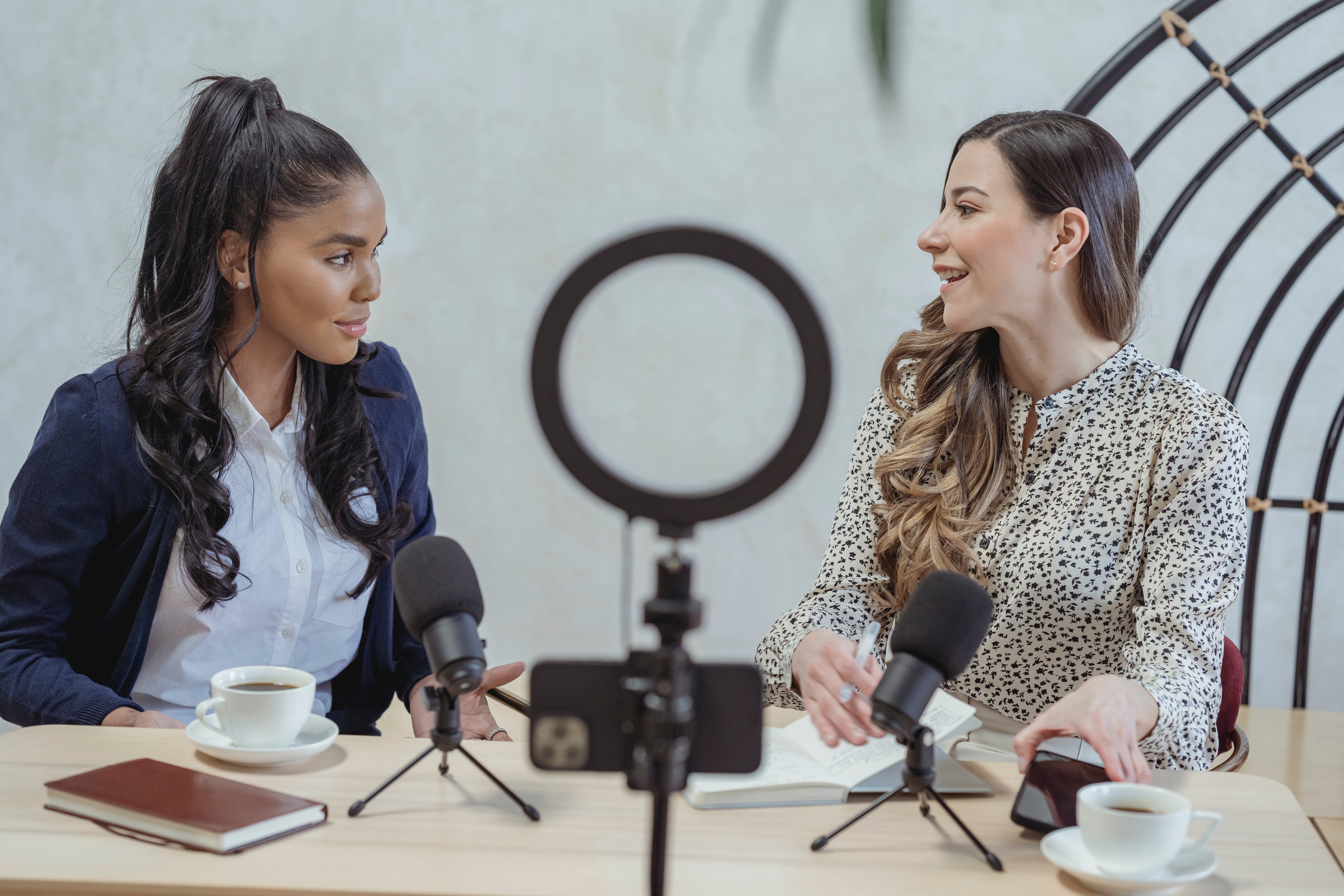 Two women with a microphone and ring light