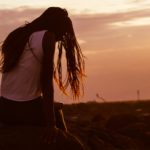 A woman sitting and looking ahead